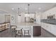 Bright and spacious kitchen features a large granite island, stainless steel appliances, and white cabinets at 12510 Fisher St, Englewood, CO 80112
