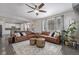 Open-concept living room with hardwood floors, neutral paint, and lots of natural light at 12510 Fisher St, Englewood, CO 80112