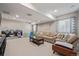 Spacious living room features neutral carpet, a sectional couch, and play area at 12510 Fisher St, Englewood, CO 80112