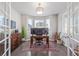 Bright home office featuring hardwood floors, large windows with great natural light, and a stylish light fixture at 12510 Fisher St, Englewood, CO 80112