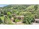 Stunning aerial view of a home nestled among lush trees and greenery in a serene neighborhood at 6201 Rain Dance Trl, Littleton, CO 80125