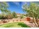 A spacious backyard offers a covered patio with a beautiful lawn, perfect for outdoor entertaining at 6201 Rain Dance Trl, Littleton, CO 80125