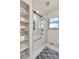 Bright bathroom featuring a modern tub with shower and sliding glass door, and built in shelves at 6201 Rain Dance Trl, Littleton, CO 80125