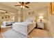 Cozy bedroom features neutral walls, ceiling fan, a decorative rug, and mirrored closet at 6201 Rain Dance Trl, Littleton, CO 80125