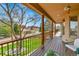 Covered deck featuring wooden support columns and railing with mountain views at 6201 Rain Dance Trl, Littleton, CO 80125