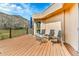 Relaxing deck area furnished with a glass table, chairs and peaceful outdoor seating at 6201 Rain Dance Trl, Littleton, CO 80125