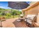 Inviting deck with outdoor seating, an umbrella, and picturesque views of the surrounding landscape at 6201 Rain Dance Trl, Littleton, CO 80125
