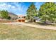 Charming home with a two-car garage and mature trees, nestled in a serene, landscaped setting at 6201 Rain Dance Trl, Littleton, CO 80125