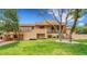 A charming two-story home boasts a spacious backyard with lush greenery and mature trees at 6201 Rain Dance Trl, Littleton, CO 80125