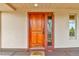 A welcoming front door with sidelight and 'Welcome' mat offers curb appeal at 6201 Rain Dance Trl, Littleton, CO 80125