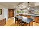 Spacious kitchen featuring a large center island with barstool seating and modern pendant lighting at 6201 Rain Dance Trl, Littleton, CO 80125