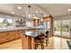 Bright kitchen with stainless steel appliances, center island with seating, and access to the outdoor deck at 6201 Rain Dance Trl, Littleton, CO 80125