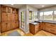 Kitchen with wooden cabinets, granite counters, and a door leading to the balcony at 6201 Rain Dance Trl, Littleton, CO 80125