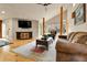 Open living room featuring hardwood floors, large windows, vaulted ceiling and comfortable seating at 6201 Rain Dance Trl, Littleton, CO 80125