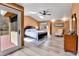 Bright main bedroom features hardwood floors, vaulted ceilings, ceiling fan and an adjacent balcony at 6201 Rain Dance Trl, Littleton, CO 80125
