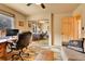 Office with desk and chair reflected in mirrored closet doors at 6201 Rain Dance Trl, Littleton, CO 80125