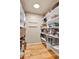 Well-organized walk-in pantry with white shelving and baskets for ample storage at 6201 Rain Dance Trl, Littleton, CO 80125