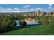 Scenic park view with a lake, building, Denver skyline, and snow-capped mountains in the background at 2500 S York St # 401, Denver, CO 80210