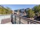 Balcony view overlooking a lively street scene with modern apartment buildings and mature trees at 2500 S York St # 401, Denver, CO 80210