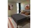 Cozy bedroom featuring a queen bed, stylish decor, and natural light from a window at 2500 S York St # 401, Denver, CO 80210