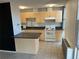 Kitchen featuring light wood cabinets, granite countertops, and white appliances at 2500 S York St # 401, Denver, CO 80210