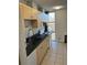 Kitchen featuring light wood cabinets, granite countertops, white appliances, and window at 2500 S York St # 401, Denver, CO 80210