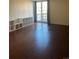 Living room with wood floors, shelving, balcony access, and bright natural light at 2500 S York St # 401, Denver, CO 80210