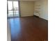 Living room with wood floors, shelving, balcony access, and bright natural light at 2500 S York St # 401, Denver, CO 80210
