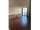Living room with wood floors, shelving, balcony access, and bright natural light at 2500 S York St # 401, Denver, CO 80210