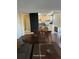 Staged living space featuring wood floors, kitchen, dining area, and a view from the window at 2500 S York St # 401, Denver, CO 80210
