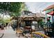 Charming outdoor seating area with cafe-style furniture, string lights, and lush greenery at 2500 S York St # 401, Denver, CO 80210