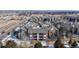 Low aerial view of multi-Gathering homes with balconies, landscaping, and snow-covered ground at 8690 Decatur St # 305, Westminster, CO 80031