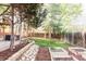Landscaped backyard with lush grass, garden beds, trees, hot tub and swing set, creating a serene outdoor space at 10422 Nelson Ct, Broomfield, CO 80021