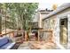 Multi-level backyard deck with outdoor seating and access to hot tub area and well landscaped backyard at 10422 Nelson Ct, Broomfield, CO 80021