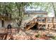 View of the home's backyard, featuring a wooden deck with stairs and a well-manicured stone and mulch yard at 10422 Nelson Ct, Broomfield, CO 80021