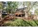 Large backyard features a tiered deck, mature trees, green grass and a fenced in area at 10422 Nelson Ct, Broomfield, CO 80021