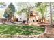 Landscaped backyard features a lawn, mature trees, a hot tub and a multi-level deck at 10422 Nelson Ct, Broomfield, CO 80021