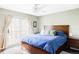 Bright main bedroom features stylish furniture and bedding, and a sliding glass door to private deck at 10422 Nelson Ct, Broomfield, CO 80021