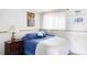 Comfortable bedroom features a cozy bed with blue and white linens, a nightstand, and soft lighting at 10422 Nelson Ct, Broomfield, CO 80021