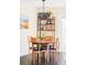 Bright dining area with modern light fixture, table, seating for four, and stylish shelving unit at 10422 Nelson Ct, Broomfield, CO 80021
