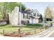 View of home with manicured lawn, fenced yard, and two-car garage on a sunny day at 10422 Nelson Ct, Broomfield, CO 80021