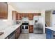 Bright kitchen featuring stainless steel appliances, quartz countertops, and dark wood cabinetry at 10422 Nelson Ct, Broomfield, CO 80021