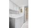 Bright laundry room features a washer, dryer, cabinets for storage, and a tiled floor at 10422 Nelson Ct, Broomfield, CO 80021