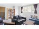 Spacious living room with a bookshelf, sofa, loveseat, and lots of natural light at 10422 Nelson Ct, Broomfield, CO 80021