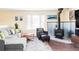 Comfortable living space with a black wood-burning stove, dark armchair, and a bright window at 10422 Nelson Ct, Broomfield, CO 80021