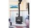Close up of wood-burning stove with tiled flooring and a decorative wall paneling at 10422 Nelson Ct, Broomfield, CO 80021