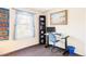 Comfortable office with hardwood floors, a black bookcase, and a desk with computer at 10422 Nelson Ct, Broomfield, CO 80021