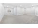 Spacious basement featuring neutral carpet and paint offering a blank canvas for customization and ample living space at 9688 Winterset Cir, Littleton, CO 80125