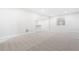Unfinished basement with neutral carpet and paint offering a blank canvas for customization and ample living space at 9688 Winterset Cir, Littleton, CO 80125
