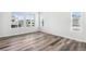 Sun-filled bedroom with hardwood floors and a view of the neighborhood at 9688 Winterset Cir, Littleton, CO 80125